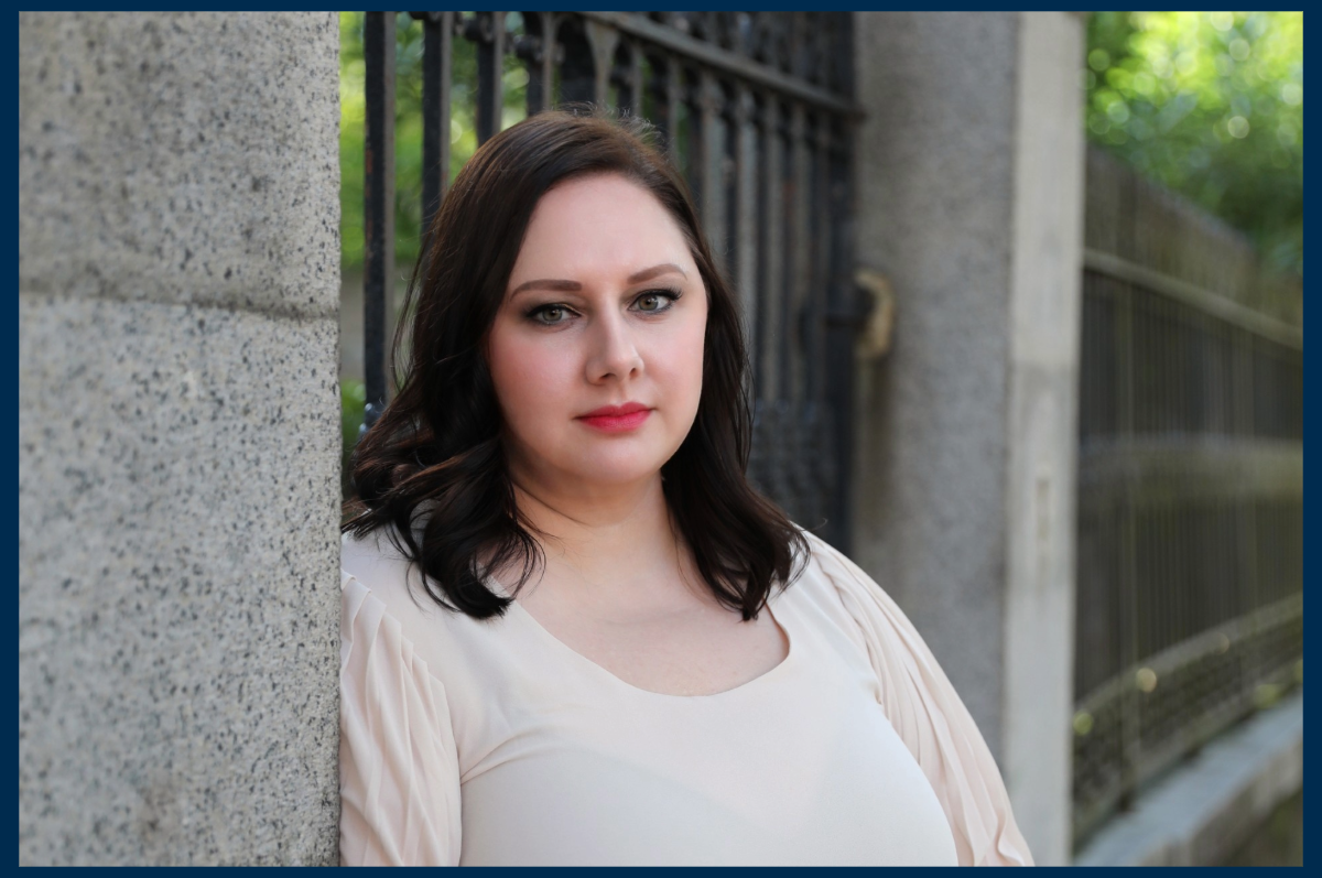 Woman leaning against fence